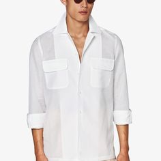 Elevate your off-duty look with this pure white Safari shirt, flaunting a prominent collar and seamless French placket. A single cuff and dual chest pockets add to the easy-going yet polished appeal. White Shirt With Hidden Button Closure For Spring, Single Breasted Shirt With Spread Collar For Summer, Summer Single Breasted Shirt With Spread Collar, White Dress Shirt With Hidden Buttons For Office, Formal Summer Shirt With Pockets, Business Tops With Pockets And Spread Collar, Business Top With Pockets And Spread Collar, White Johnny Collar Shirt For Spring, Formal Shirt With Pockets And Lapel Collar