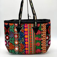 Attractive Color Combination. Mirror And Thread Work Done All Over The Tote. Black Cotton Fabric Lining Inside. One Small Inside Pocket With Zipper Closure. Zipper Closure On Top. Ethnic Tribal Design. Attractive Bright Color Combination. Size: 19”X12.5”X 5”. Handle Drop 10” Handmade By Tribe Azure Fair Trade Artisans. Exquisite Handmade Woven Unique Patchwork Tapestry And Mirrors.Each Bag Is Individually Made By Hand, Giving Each Bag A Unique Touch. Handicraft, Fair Trade, Bohemian, Banjara Bohemian Shoulder Bag For Shopping, Multicolor Embroidery Beach Bags, Chic Black Embroidered Shoulder Bag, Multicolor Embroidery Shoulder Bag For Beach, Multicolor Embroidered Shoulder Bag For Summer Festivals, Handmade Black Bohemian Bags, Embroidered Black Summer Bags, Summer Festival Multicolor Embroidered Shoulder Bag, Black Embroidered Bags For Summer