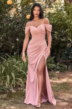 This simply sophisticated gown is perfection for your bridesmaids' party or more modern formal event. The off the shoulder pleated sleeve drapes around the shoulders while a thin strap holds the gown. A sweetheart neckline pleats into the side seam for a flattering fit opening up to a subtle leg slit. Dusty rose Off shoulder Leg slit Sleeve drapes Cold Shoulder Gown, Prom Dress With Train, Modern Bridesmaid, Shoulder Off, Dress With Train, Cinderella Divine, Off Shoulder Gown, Long Bridesmaid Dress, فستان سهرة