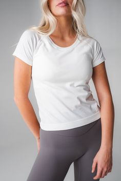 Our Energy Tee is designed for high performance activities as well as for on the go. This seamless short sleeved tee is fitted yet flexible and hits at the top of the waistband. Breathable Relaxed Fit T-shirt For Athleisure, Breathable Short Sleeve T-shirt For Light Exercise, High Stretch Athleisure T-shirt For Workout, Short Sleeve T-shirt For Workout, Fitted Breathable T-shirt For Athleisure, Basic Go-dry T-shirt For Workout, Sporty Athletic Fit T-shirt For Light Exercise, White Short Sleeve Workout T-shirt, Basic Short Sleeve Workout Top