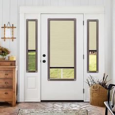 a white front door with two windows and blinds on the top one side, next to a brown rug