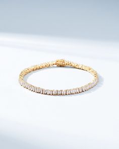 This Classic Diamond Mini Baguette Tennis Bracelet is one of our bestselling styles. We love this piece for its elegance and wear-ability. Beautiful mini baguette diamonds are meticulously set in a vertically staggered setting for a modern feel. Stack it next to one of our bangles for an elevated look. Details 18k rose gold, yellow gold or white gold 2.90 carats of baguette white diamonds Bracelet measures 7 inches in length Box clasp with safety lock fastening 4mm width Ref: AKB348 Modern Diamond Bracelet With Baguette Cut Accents, Modern Baguette Cut Diamond Bracelet With Accents, Modern Diamond Tennis Bracelet With Baguette Cut, Modern Baguette Cut Diamond Bracelet, Modern Tennis Bracelet With Baguette Diamonds And Cubic Zirconia, Elegant Tennis Bracelet With Baguette Diamonds As Gift, Fine Jewelry Baguette Cut Diamond Bracelet, Modern Wedding Tennis Bracelet With Baguette Diamonds, Modern Tennis Bracelet With Baguette Diamonds For Wedding