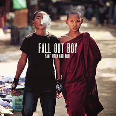 two men walking down the street with their hands in each other's pockets, one wearing a t - shirt that says fall out boy