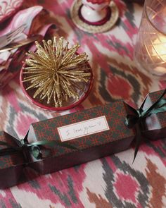 a table topped with boxes and candles on top of a table