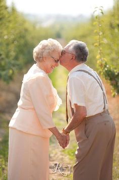 an older couple holding hands on a dirt road