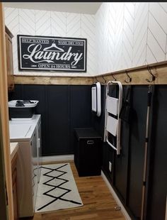 a kitchen with black cabinets and white walls