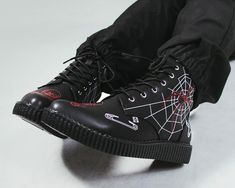 We wanted to do our part in supporting local businesses & artists during the pandemic. We teamed up with various artists and used our platform to showcase their talents on our iconic creepers. Using our shoes as their canvas, Tattoo Creepers were born. These T.U.K. x Eliza Sidney boots feature a black faux leather upper with red and white illustrations. Have 7-eyelet lace up detail and a platform sole height that measures 1 ¼” at the heel and ¾” in the front. Has removable memory foam insoles fo Vampire Shoes Men, Mens Goth Shoes, Goth Boots Men, Spider Boots, Creepers Shoes Outfit, Eliza Sidney, Canvas Tattoo, Creeper Boots, Fire Clothes