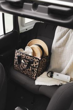 the back seat of a car with hats and other items in its bag on it