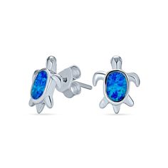 Show off your love for the ocean with these lively blue lab-created opal sea turtle stud earrings in silver. Crafted in sterling silver Each earring features a sea turtle glistening with an oval-shaped iridescent blue lab-created opal cabochon inlay as the shell. These post earrings secure comfortably with wire backs. Opal Birthstone, Iridescent Blue, Nautical Jewelry, Turtle Pendant, Synthetic Opal, Opal Earrings Stud, Blue Hawaiian, Opal Studs, Animal Earrings