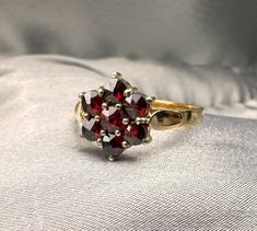 A beautiful genuine antique German silver garnet ring (natural stone), hallmarked '900' for silver, US Size 5 3/4, in good antique condition, would make a nice gift for someone special! Material: 900 silver, garnet Weight: 1.8 g US Size: 5 3/4 (EU 51 1/2) Box on photos is NOT included. PLEASE LOOK AT THE PICTURES, THEY ARE PART OF THE DESCRIPTION AND ARE THE ACTUAL ITEM YOU WILL RECEIVE. Vintage Garnet Cluster Ring As Gift, Vintage Red Garnet Cluster Ring, Vintage Garnet Cluster Ring With Gemstone, Vintage Ruby Cluster Ring Hallmarked, Vintage Garnet Ring For Anniversary, Vintage Garnet Cluster Ring For Anniversary, Vintage Round Garnet Cluster Ring, Vintage Garnet Ruby Ring For Anniversary, Victorian Ruby Cluster Ring With Gemstones