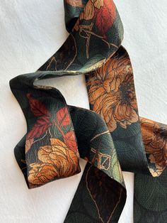 Elegant and colorful antique style Gambiered Canton Silk Skinny Scarf. Double-sided print with size of 150 cm x 6.5 cm / 60 in x 2.6 in, Gambiered Canton Gauze, also called "fragrance cloud silk", "soft gold" or "mud silk", It uses pure natural silk as its grey fabrics, and dye yam plant in Canton province as its dyestuff. The dyeing and finishing processes usually go through 16 steps of traditional manual techniques. This fabric is light, organic, highly breathable, feels comfortable and pleasantly cool, beneficial to the skin, easy to wash and does not wrinkle. Fabric shines very subtly, giving an impression of low-key luxury. The fabric will become softer as you wear it longer time. Care instruction: gently hand wash in cold water, hang to natural air dry. Stored in a cool, dry and dark Vintage Silk Scarf For Formal Occasions, Vintage Silk Rectangular Scarf, Vintage Silk Scarf With Floral Print, Vintage Rectangular Silk Scarf As Gift, Bohemian Rectangular Silk Scarf, Vintage Multicolor Rectangular Silk Scarf, Multicolor Vintage Silk Scarf For Formal Occasions, Vintage Multicolor Silk Scarf For Formal Occasions, Vintage Patterned Silk Scarves