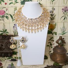 Indulge in the timeless allure of South Asian elegance with our Laasya Kundan Necklace Set. Crafted with exquisite precision, this set exudes opulence with high-quality Kundan stones and lustrous pearls. The necklace boasts intricate detailing, while the accompanying jhumka earrings showcase traditional charm with their Kundan and pearl embellishments. Elevate your ensemble with this stunning ensemble, perfect for special occasions and celebrations. Embrace the essence of Indian jewelry traditions with this captivating set, a true testament to craftsmanship and beauty. Specifications Materials used: Kundan, Polki Stones, Pearls, Gold Plating Gold Kundan Necklace, Indian Necklace Set, Kundan Choker Set, Kundan Necklace Set, Kundan Choker, Wedding Jewelry Set, Indian Necklace, Kundan Necklace, Choker Set