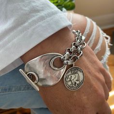 Awesome chunky bracelet decorated with antique toggle clasp and elephant charm.  Made of a mixt of bright silver rolo and cable chain with antique silver clasp and charm, you'll be charmed by the stylish look of this bracelet. The chains are innoriginal and platinum silver plated stainless steel. The toggle clasp and elephant charm are in antique silver Zamak (real 925 antique silver plated pewter).  On picture, 6.5 inches wrist showing the 8 inches bracelet. Add approximately 1.25 - 1.5 inch (37mm) to your wrist size. You will receive this beautiful bracelet in a box decorated with bow. Thank you for visiting! Chunky Silver Bracelets, Chunky Silver Jewelry, Top Jewelry Trends, Chunky Silver Jewellery, Chunky Silver Bracelet, Chunky Charm Bracelet, Silver Bracelet For Women, Junk Jewelry, Chunky Bracelet