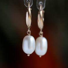 "Add a touch of elegance to any outfit with these beautiful 14k gold pearl earrings. White freshwater pearls are handpicked for their luster and beauty and dangle gracefully from 14k gold leverback closures. Luxurious and durable, these earrings are a great gift for any occasion, like a wedding, or for everyday wear.  MATERIALS * Freshwater Pearls * 14k Gold or 18k Gold * beautiful white branded gift box * card about white pearl SIZE: pearls: 10x7.5 mm;  earrings: 3 cm or 1 3/16\" MAKE A SET: Ma Elegant Oval Huggie Earrings For Everyday, Classic Oval Hoop Earrings For Wedding, Elegant Huggie Clip-on Earrings, Elegant Everyday Round Clip-on Earrings, Huggie Earrings With Lever Back For Wedding, Elegant Hoop Clip-on Earrings For Formal Occasions, Elegant Hoop Clip-on Earrings For Formal Events, Elegant Small Hoop Yellow Gold Clip-on Earrings, Elegant Oval Hoop Earrings For Everyday