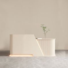 a white planter sitting on top of a cement floor next to a light colored wall