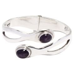 This stunning vintage Mexican sterling silver bangle bracelet will make a stunning addition to any jewelry collection! Crafted from sterling silver, this gorgeous bangle bracelet features 6.9ctw of amethysts. The bracelet is hinged for easy on and off, and measures 6.25 inches in length. Perfect for adding a luxurious touch to any ensemble, this Mexican silver jewelry makes an excellent gift for any occasion. Let this Vintage Mexican 6.9ctw Amethyst Bangle Bracelet in Sterling Silver be the stan Formal Amethyst Jewelry With Polished Finish, Adjustable Gemstone Bangle For Formal Occasions, Unique Bangle With Polished Finish, Unique Round Bangle With Polished Finish, Anniversary Sterling Silver Bangle With Silver Clasp, Formal Polished Open Band Bangle, Adjustable Silver Bangle Fine Jewelry, Adjustable Silver Bangle In Fine Jewelry Style, Sterling Silver Gemstone Bangle For Anniversary