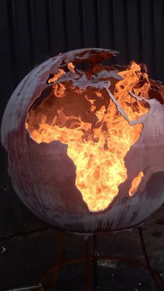 a fire pit made to look like the world on fire