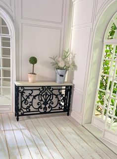 there is a potted plant on top of the table in front of an arched window