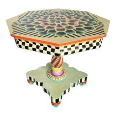 an artisticly designed table with colorful designs on it's top and bottom, against a white background