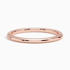 a rose gold wedding ring on a white background