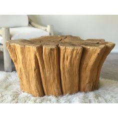 a piece of wood sitting on top of a white rug