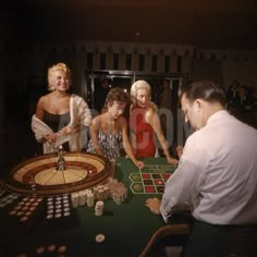 three women and two men playing roulejack in a casino