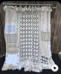 the curtain is made out of different types of laces and fabric, with an attached tie