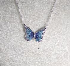 Pretty enamel and imitation rhodium-plated, 35x25mm single-sided butterfly - shown here in blue and green with glitter (6 color choices - see photos). Necklace is made with silver filled rolo chain with a lobster clasp - select length during checkout. Comes in a gift box. Photos - 1, 2, & 3 = Blue and Purple Photo 4 - Black Photo 5 - Green Photo 6 - Orange Photo 7 - Pink Photo 8 - Purple Orange Photo, Purple Photo, Butterfly Necklace Silver, Pretty Jewelry Necklaces, Black Photo, Pink Photo, Green Photo, Magical Jewelry, Jewelry Accessories Ideas