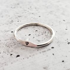 This dainty and charming ring is hand-crafted from high-quality sterling silver, ensuring both durability and style. Choose your favorite initial to be hand stamped on the ring, making it a delightful and meaningful gift for yourself or someone special. With meticulous precision, we create a unique design that adds a playful flair to the ring's overall allure. Express your individuality and show off your style by stacking this fabulous Sterling Silver Initial Ring with other favorites. Whether y Personalized Sterling Silver Engraved Ring, Silver Hand Stamped Stackable Promise Rings, Sterling Silver Stackable Initial Ring Open Design, Meaningful Stackable Sterling Silver Rings, Meaningful Sterling Silver Engraved Ring, Adjustable Stackable Initial Ring As Gift, Minimalist Hand Stamped Midi Rings, Personalized Sterling Silver Stackable Open Rings, Meaningful Silver Stackable Rings Gift