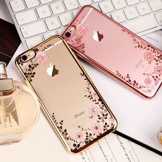 two iphones sitting next to each other on top of a desk with a bottle of perfume