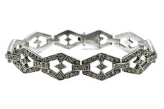 This is a beautiful antique Art Deco era (1920 - 1940) 935-grade silver geometric style/design link bracelet with clear paste stones. The bracelet weighs 28.64 grams in total. The bracelet comes with a presentation box displayed in the images (not original). History: The Art Deco (French - Arts Décoratifs) received its name after the famous exposition in Paris Exposition of Modern Decorative and Industrial Arts. However, the movement and its significant style started much earlier, in Paris, arou Art Deco Diamond Bracelet As Gift, Art Deco Diamond Accented Bracelet, Art Deco White Gold Diamond Bracelet, Art Deco Diamond Bracelet For Anniversary, Silver Bracelets With Single Cut Diamonds For Evening, Art Deco Hand-set Silver Jewelry, Art Deco Diamond Bracelet With Accents, Art Deco Silver Jewelry With Hand Set, Art Deco Silver Jewelry With Hand Set Details