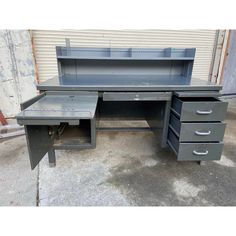 an old metal desk with drawers on it