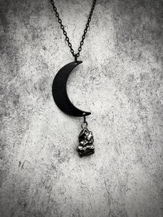 This unique one of a kind crescent moon meteorite necklace features a chunk of genuine space rock that is between 4,000 - 5,000 years old. The meteorite specimen was collected at the Campo del Cielo crater field in Argentina. Campo del Cielo is a class IAB iron meteorite, comprised of about 93% iron and 6.7% nickel, plus a small amount of other trace elements. Only about 5% of meteorites are iron, which makes the Campo del Cielo fragments highly collectable. The meteorite fragment charm is hung Gothic Sterling Silver Necklaces With Moon Phase, Mystical Moon-shaped Metal Necklace, Gothic Adjustable Necklace With Moon Charm, Gothic Pendant Necklaces With Moon Charm, Bird Skull Jewelry, Gothic Necklaces With Moon Charm Pendant, Waning Moon, Space Necklace, Crow Pendant