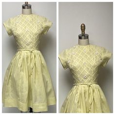 1950's sunny yellow fine organdy or batiste summer dress, with short sleeves, fitted bodice, and full skirt. The sleeves are self faced with piping accents, also at the round neckline. Bias folds create a lattice design on the front bodice, with floral appliques and rhinestones. There is a double corded waist tie. On the far left and far right, the rhinestones have been replaced, but don't look the same. There is a fine nylon tulle under slip that adds just a bit of poof. there is one pin hole o Retro Vintage Dress For Spring Events, Short Sleeve Vintage Fashion Dresses For Spring, Spring Vintage Fashion Short Sleeve Dresses, Vintage Fashion Spring Dress With Short Sleeves, Spring A-line Vintage Dress For Vintage Events, Yellow A-line Vintage Dress For Summer, 1950s A-line Vintage Summer Dress, Yellow Fitted Short Sleeve Dress, 1950s Style Vintage Dress For Summer Events