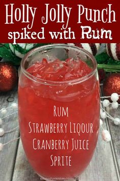 a red drink in a glass with the words holly jolly punch spied with rum