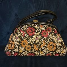 Fabulous Vintage 1950s Needlepoint Handbag Has Lovely Floral Design. Black Background With Red, Olive Green, Purple, Yellow, Gold And Ivory Flowers. Fabric Lined With Zipper Pocket. Purse Snaps Closed And Has Black Faux Leather Handles And Trim. Excellent Condition Purse Measures 17” X 6” Across The Bottom And @9” Tall. Handles Are @13” Across. Retro Embroidered Evening Bags, Vintage Embroidered Evening Bags, Vintage Black Bag For Vintage Events, Black Vintage Bags For Vintage Events, Retro Clutch Bag For Vintage Events, Retro Black Bags For Vintage Events, Vintage Embroidered Formal Bags, Retro Clutch For Vintage Events, Mid-century Black Bags For Vintage Style