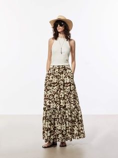 MO&Co. Women's Flowy Floral Print Skirt Introducing our newest addition to your holiday wardrobe - the Silk Cotton Flowy Maxi Skirt! Made from a flowing silk-cotton blend, it features a maxi silhouette that is both comfortable and flattering. It has a ruched pleated and elastic waist adds a touch of sophistication, while the floral print and side slip pockets add a playful and practical touch. Paired with a simple tank top and sandals for a casual daytime look Features : - Flowy maxi A-line silh Flowy Maxi Skirt, Simple Tank Tops, Flowy Maxi Skirts, Pockets Design, Floral Print Skirt, Holiday Wardrobe, Print Skirt, Printed Skirts, Floral Tops