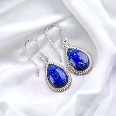 Simple and elegant, this 925 Sterling Silver Lapis Lazuli studded Earrings will make your look fashionable and classy. Its classy shine and flawless finish enhances its majestic charm and makes it more adorable. ----------------------------------- Welcome TO Our Shop Shnaya Jewels ----------------------------------- ""Elegant Lapis Lazuli Earrings, Gemstone Earrings, Blue Drop & Dangle Earrings, 925 Sterling Silver Jewelry, Birthday Gift, Earrings For Love"" SKU : EE-9-31 Gemstone : Lapis Lazuli Stone Shape : Pear Metal : Sterling Silver Metal Purity : 925 Length : 1.4 Inches * Jewelry Care Tips:- ----------------------- [1] Store it properly: Store your jewelry in separate compartments or pouches to prevent scratching and tangling. This is particularly important for delicate pieces or tho Sterling Silver Sapphire Gemstone Earrings, Sapphire Sterling Silver Drop Earrings, Blue Sterling Silver Teardrop Earrings, Sapphire Dangle Earrings In Sterling Silver, Sapphire Sterling Silver Dangle Earrings, Elegant Blue Sterling Silver Earrings, Teardrop Sapphire Sterling Silver Jewelry, Blue Sterling Silver Teardrop Earrings For Gift, Studded Earrings