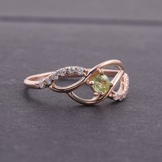 "Peridot ring, Cute ring, Multistone ring, Fine ring, Twist ring, Birthstone ring, Gemstone ring, Custom stone ring, Personalize ring WE OFFER UNLIMITED PERIOD INSTALLMENTS PLAN This is a beautiful, stunning, feminine ring that works well for all occasions, styles, and ages. You will love it! Ring information: Main stone: Peridot Approximate size: 3mm Approximate weight: 0.13ct Accent stone: Cubic zirconia Metal type: Gold Metal stamp: 14k Gold Customization / Replacements It's easy to create je Diamond Ring With Center Stone For May Birthstone, May Birthstone Crystal Ring With Accent Stones, Open Birthstone Ring For Promise, May Birthstone Gemstone Rings With Round Stone, Promise Crystal Ring With May Birthstone, Open Emerald Ring With Accent Stones, Emerald Open Ring With Accent Stones, May Birthstone Crystal Promise Ring, May Birthstone Gemstone Rings