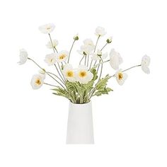 a white vase filled with lots of white flowers