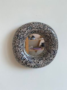 a black and white animal print mirror hanging on the wall