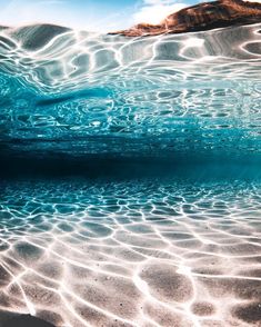 an underwater view of the water and sand