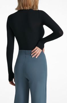 This buttery-soft turtleneck top fits like a second skin thanks to ample stretch that's blended right in. Turtleneck Long sleeves 84% nylon, 16% elastane Machine wash, dry flat Imported High Stretch Smoothing Solid Color Tops, Solid Stretch Tops With Smoothing Details, Solid Stretch Smoothing Top, Solid Micro-elastic Nylon Tops, Solid Color Smoothing Stretch Top, Stretch Elastane Turtleneck, Stretch Solid Color Elastane Turtleneck, Sleek Stretch Turtleneck Tops, Stretch Solid Color Turtleneck