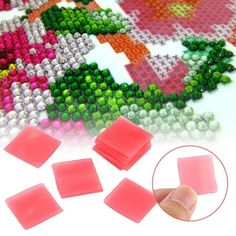 several pieces of plastic beading on top of a white surface with pink and green beads