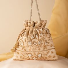 "Beautiful Wedding Indian Katdana Pearl Beaded Bridal Potli Purse Bag | Hand Embroidered Satin Cream Fabric Drawstring Pouch Purse Mobile Bag Package Contents: 1 Size: 10\" x 8\" Designed with the heart, this beautiful Potli or batawa bag are eye catchy and made of premium material. Key Features: Embroidery art work.  This potli is good match with both Indian and western outfits and are superb for wedding and festive parties. This would be best complement to your designer saree, lenhga or any other kind of dress. This is the combination of traditional and modern embroidery work. This is enough to keep your accessories and all needed essentials and it can be a best gift for any woman." Polti Bag, Potli Purse, Mobile Bag, Pouch Purse, Potli Bags, Wedding Indian, Cream Fabric, Modern Embroidery, Drawstring Pouch