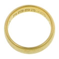 Measuring 5mm in overall width. Hand engraved inside shank. Fashioned in 22k yellow gold. Full hallmarks for Birmingham England; 1914. Size 5. Antique 22k Gold Wedding Ring, Heirloom Yellow Gold Thick Band, Heirloom Thick Band In Yellow Gold, Ceremonial Yellow Gold Engraved Ring With Decorative Band, Ceremonial Yellow Gold Wedding Band With Decorative Details, Timeless Gold Engraved Ring With Decorative Band, Yellow Gold Engraved Ring Stamped 14k For Marriage, Heirloom Yellow Gold Wedding Ring With Thick Band, Vintage 22k Gold Wedding Rings