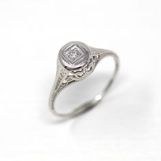 an antique style diamond ring on a white background