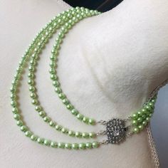 Handcrafted triple strand light green Czech glass Pearl cz clasp necklace, high quality Czech glass pearls in a light green tone, elegant box clasp set in silver plate with clear cubic zirconia stones, silver spacers, one of a kind elegant statement piece, 16"; 18" and 20" strands.  6976 Elegant Green Double Strand Jewelry, Formal Green Pearl Necklace With Round Beads, Formal Green Pearl Necklace, Elegant Lime Green Beaded Jewelry, Elegant Lime Green Jewelry With Round Beads, Green Tone, Clasp Necklace, Box Clasp, Accessories Jewelry Necklace