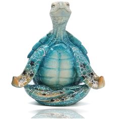 a turtle statue sitting on top of a white surface