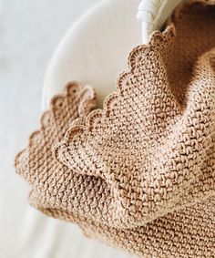 a crocheted bag sitting on top of a white plate